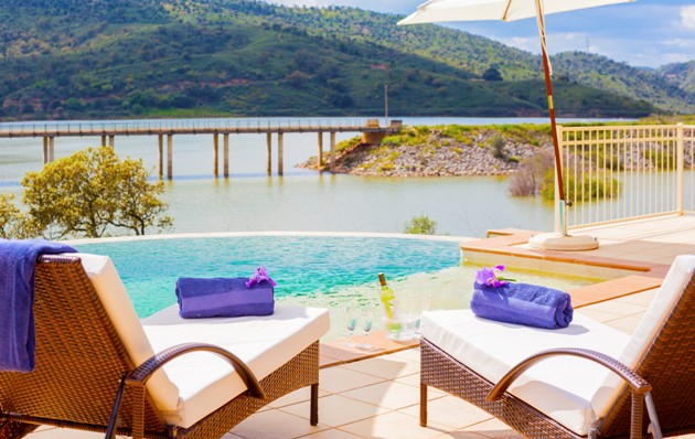 Loungers and wine cooler by infinity pool on the river