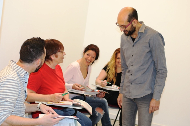 Over 50s students learning Spanish in classroom with teacher