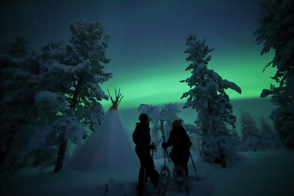 couple snowshoeing in finland