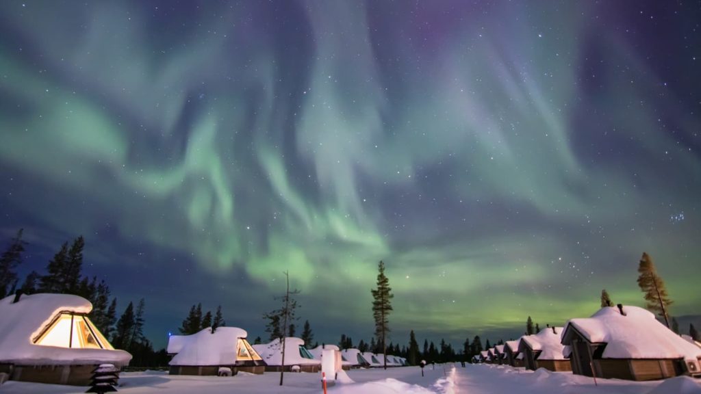 northern lights over resort huts