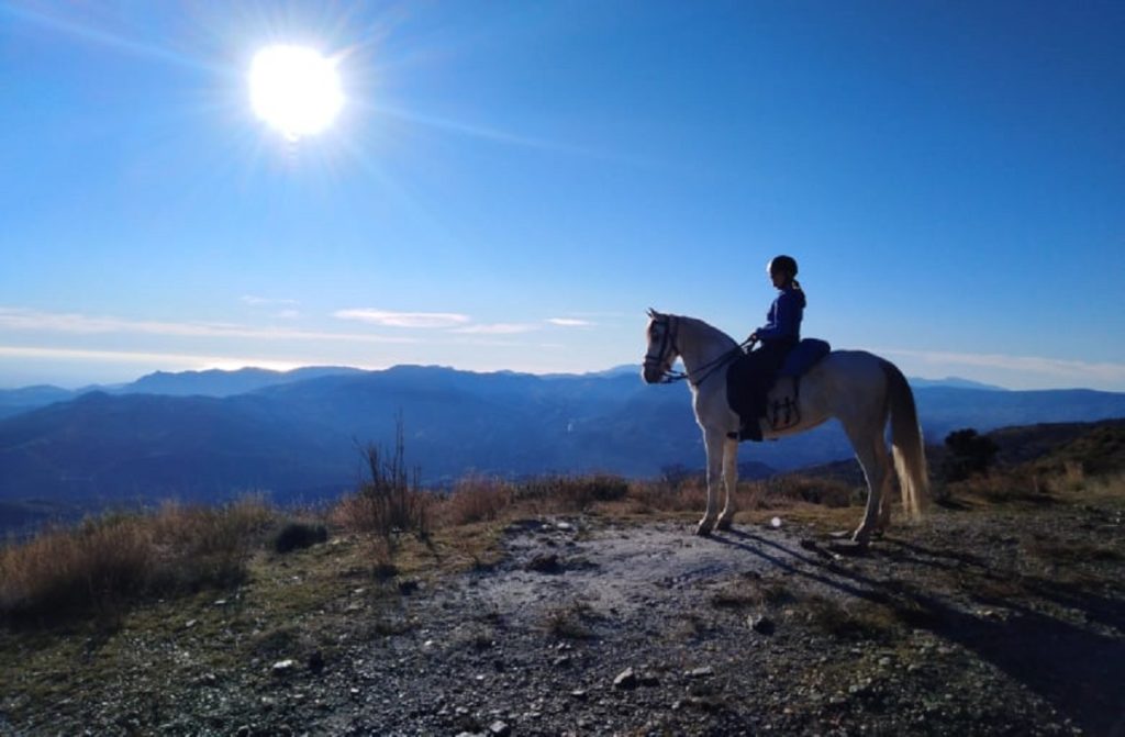 person looking at a view on horseback in andalucia