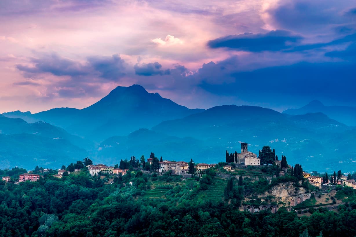 purple sky over hilltop village