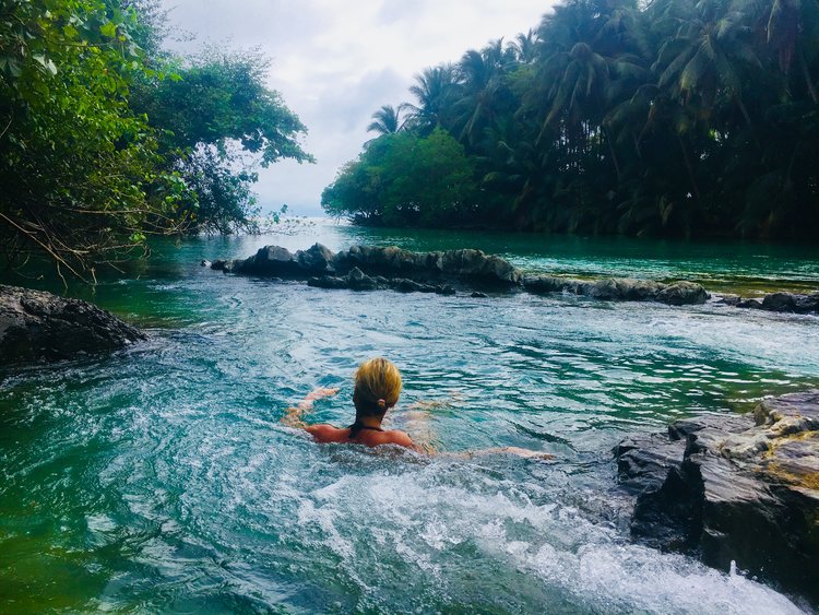 person relaxing in a natural pool in costa rica