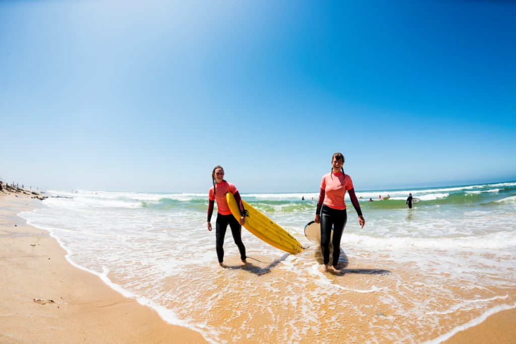 surfers on beach in Portugal