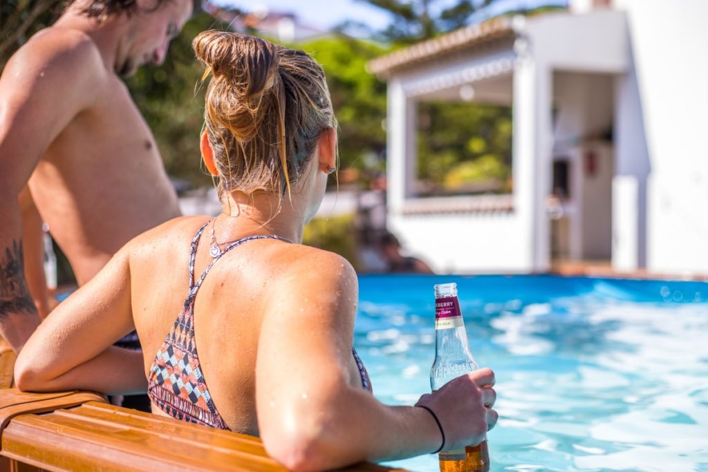 guest with beer in pool