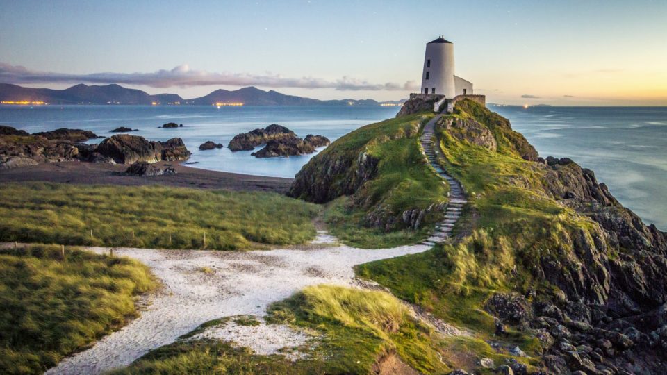 lighthouse on hill by the sea