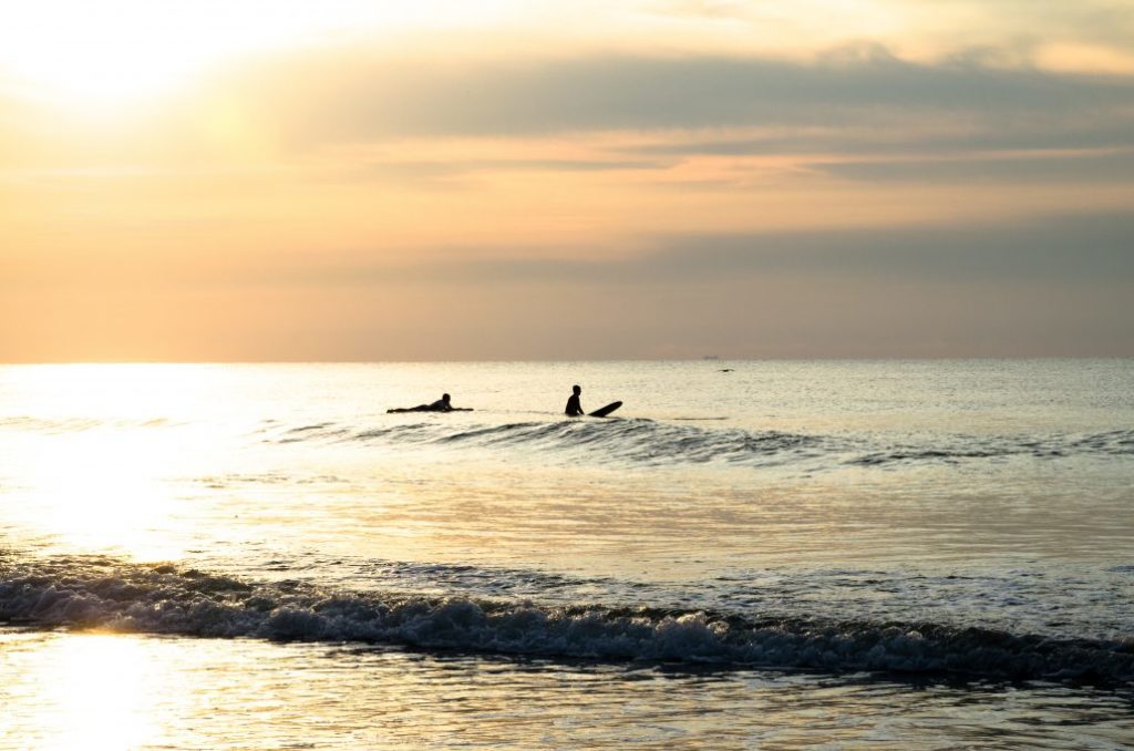 surfing at sunset in cornwall