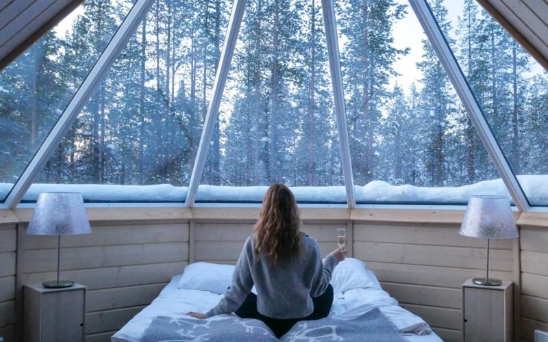 woman drinking champagne in Finnish snow hut