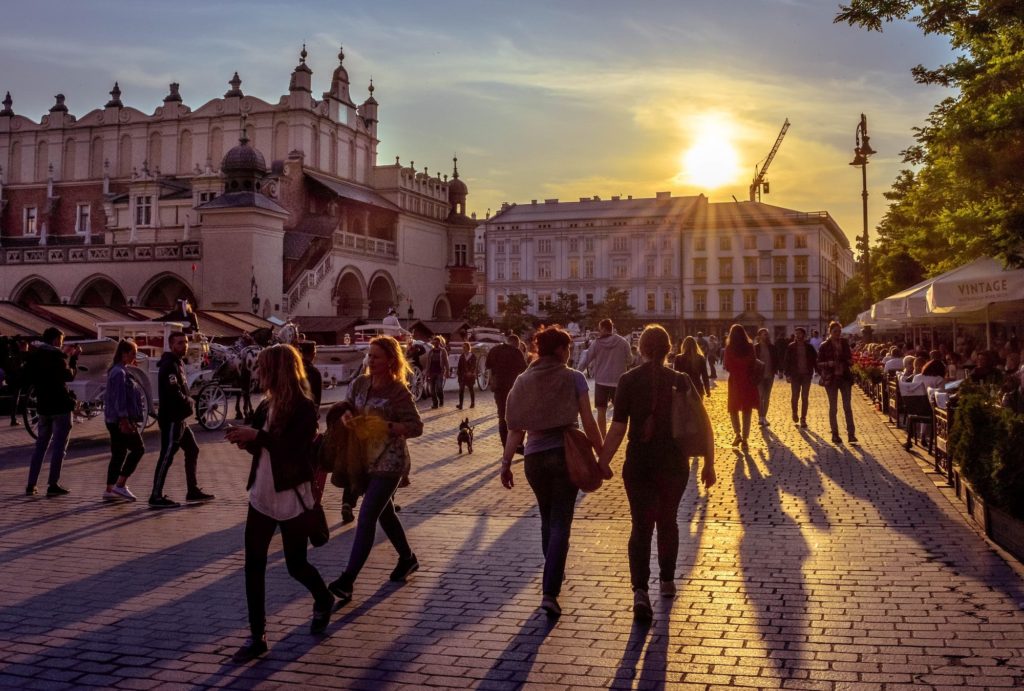 walking in Krakow square at sunset