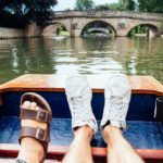 two pairs of feet up on punting boat