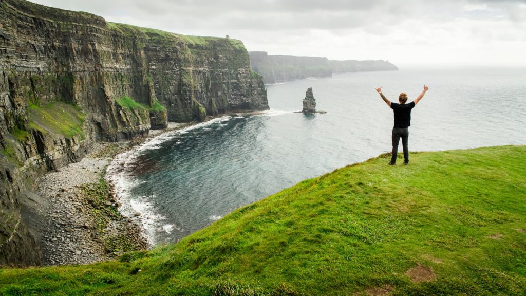 man hiking along coast in west Ireland