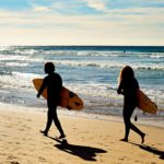 surfers on beach in portugal