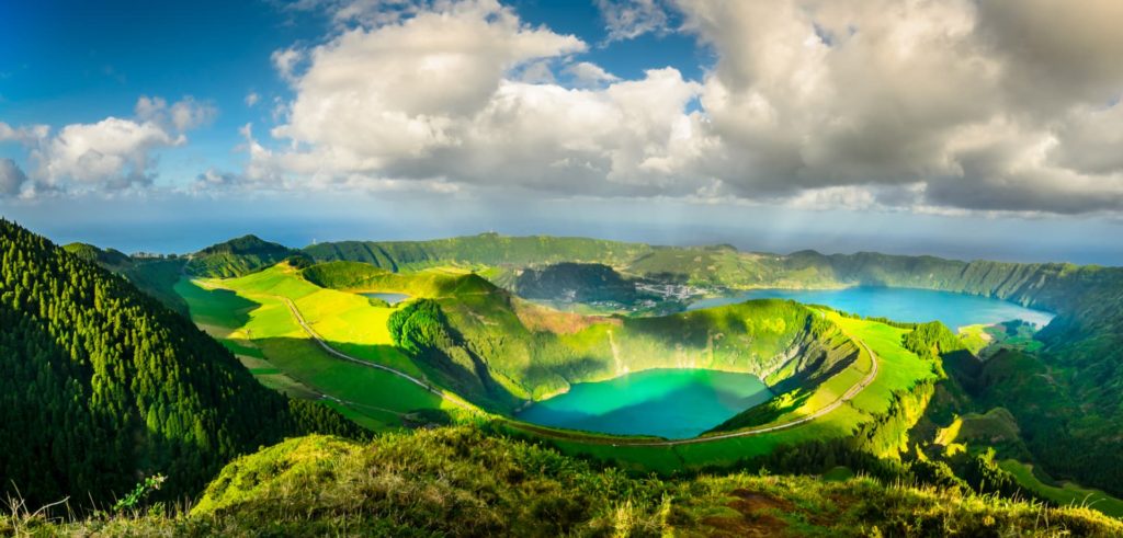 blue lake surrounded by green mountains