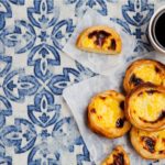 coffee and Portuguese tart on tiled table