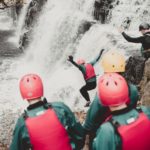 coasteering group jumping into water