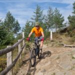 man mountain biking through Welsh countryside