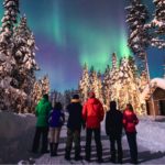 small group watching northern lights in iceland