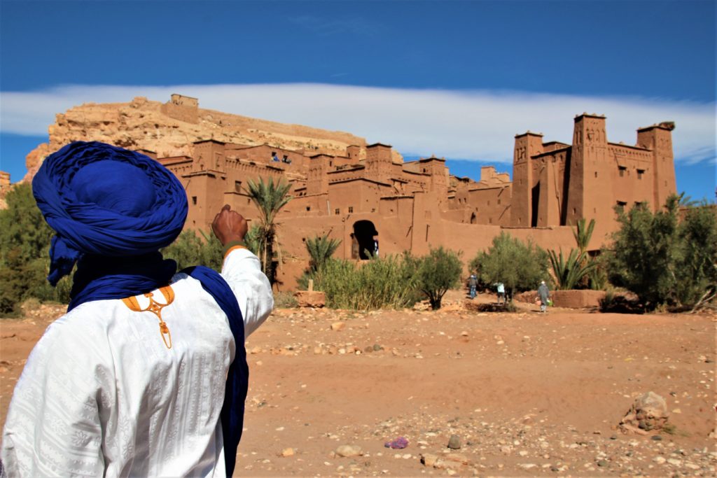 man pointing at ancient fortress morocco