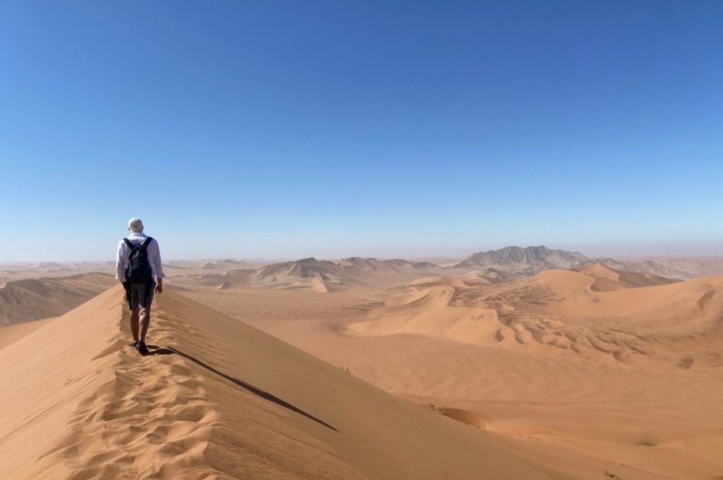 walking on a sand dune in namibia