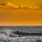 person surfing at sunset