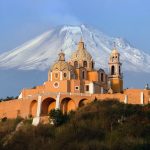 church in the foreground of a volcano