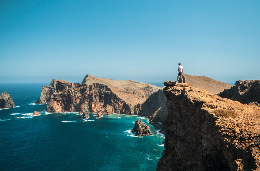 person standing on sea cliffs in madeira