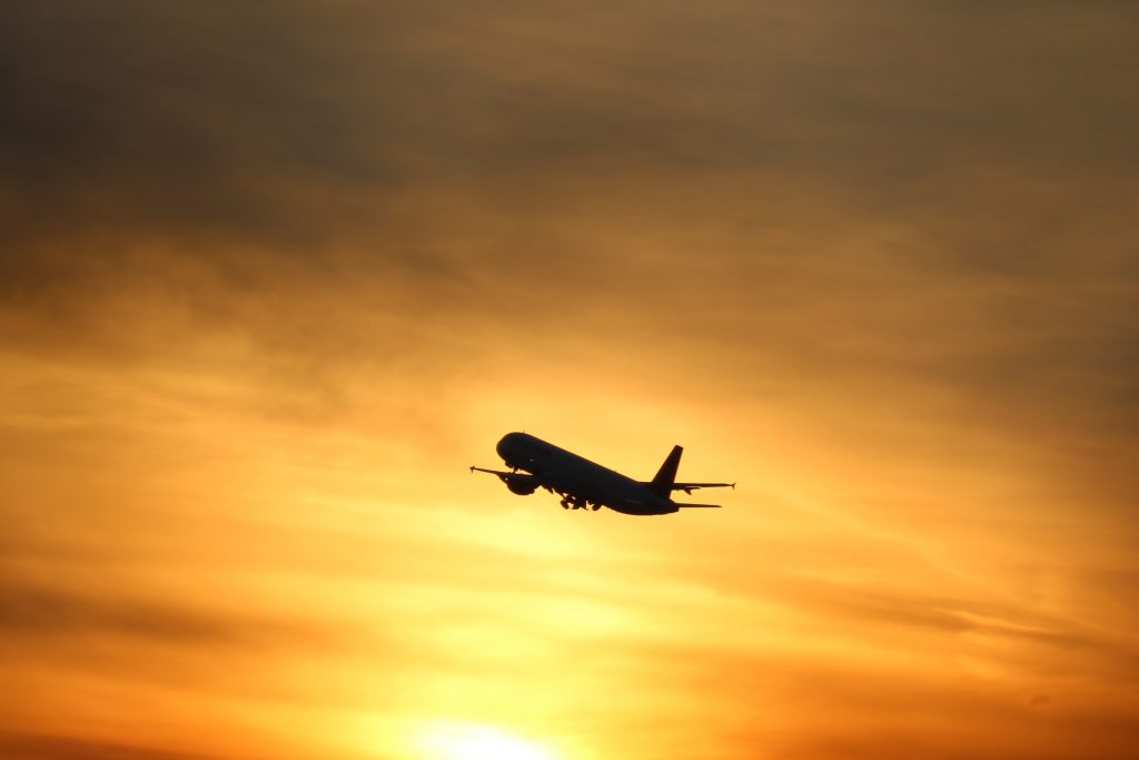 aeroplane flying in a sunset